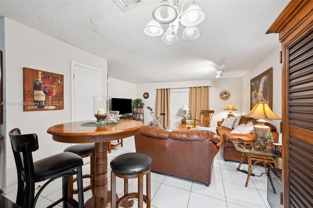 4119 NE 21st Ter, Lighthouse Point, FL 33064 - living area featuring a textured ceiling, light tile patterned floors, and a chandelier