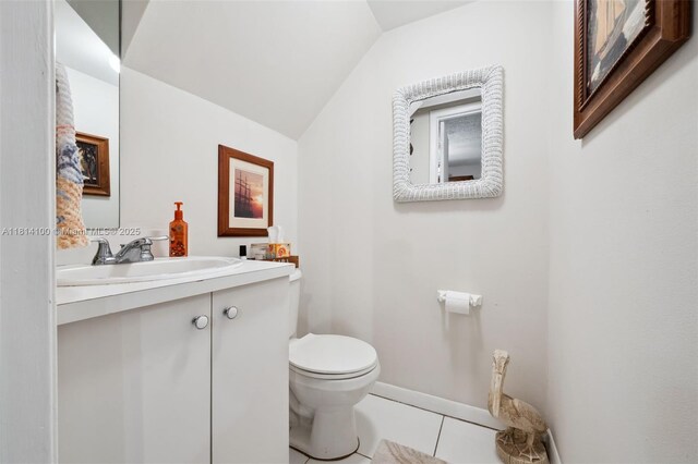 4119 NE 21st Ter, Lighthouse Point, FL 33064 - half bath featuring toilet, lofted ceiling, tile patterned flooring, vanity, and baseboards