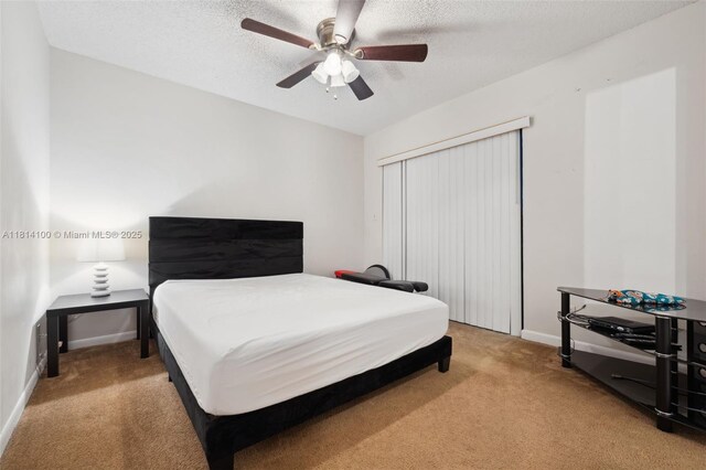 4119 NE 21st Ter, Lighthouse Point, FL 33064 - bedroom featuring light colored carpet, baseboards, a ceiling fan, and a textured ceiling