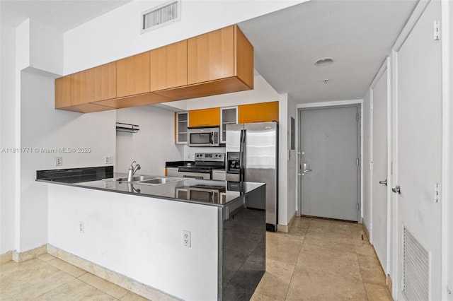 1750 N Bayshore Dr Unit 2809, Miami, FL 33132 - kitchen featuring stainless steel appliances, a peninsula, dark countertops, a sink, and baseboards