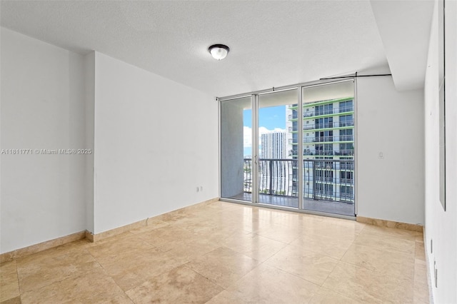 1750 N Bayshore Dr Unit 2809, Miami, FL 33132 - spare room with a wall of windows, a city view, a textured ceiling, and baseboards