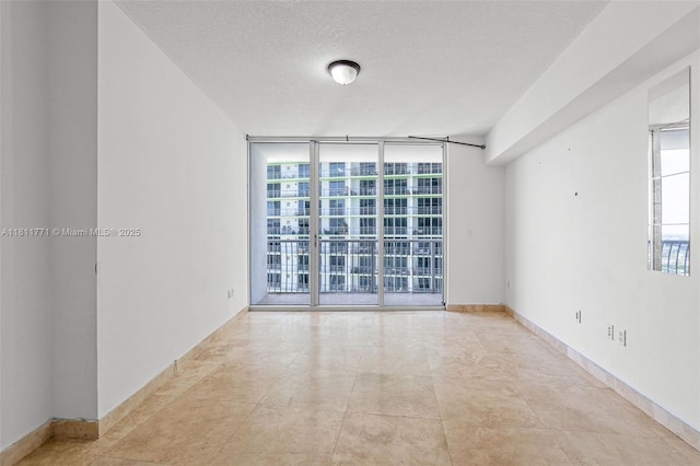 1750 N Bayshore Dr Unit 2809, Miami, FL 33132 - empty room with expansive windows and a textured ceiling