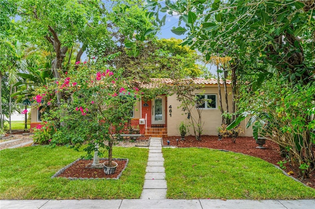 461 Morningside Dr, Miami Springs, FL 33166 - view of front facade featuring stucco siding, a front yard, and a tiled roof