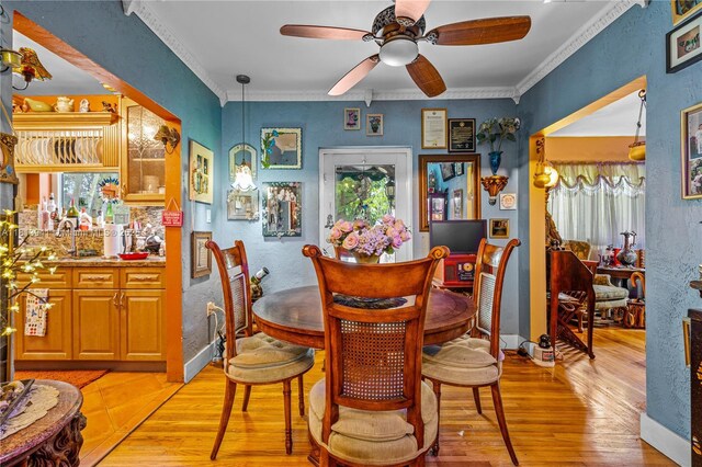 461 Morningside Dr, Miami Springs, FL 33166 - dining space with light wood-style floors, ceiling fan, ornamental molding, and a textured wall