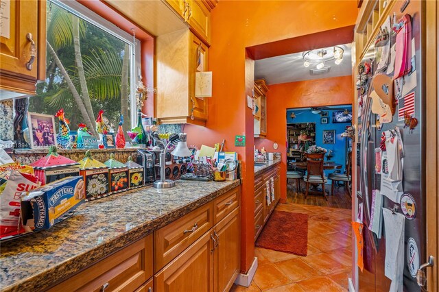 461 Morningside Dr, Miami Springs, FL 33166 - kitchen featuring brown cabinets, stone countertops, and light tile patterned floors