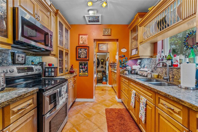 461 Morningside Dr, Miami Springs, FL 33166 - kitchen with stainless steel appliances, a sink, tasteful backsplash, and glass insert cabinets