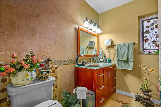 461 Morningside Dr, Miami Springs, FL 33166 - half bath with vanity, tile walls, toilet, tile patterned flooring, and baseboards