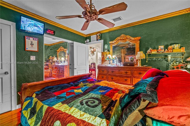 461 Morningside Dr, Miami Springs, FL 33166 - bedroom featuring a textured wall, crown molding, wood finished floors, and a ceiling fan