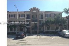 22921 SW 88th Pl Unit 304, Cutler Bay, FL 33190 - view of property featuring uncovered parking