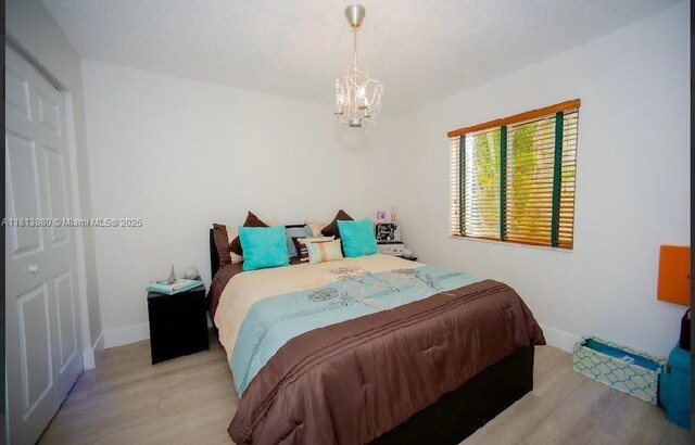 1353 Majesty Ter, Weston, FL 33327 - bedroom with a chandelier and light wood-style floors