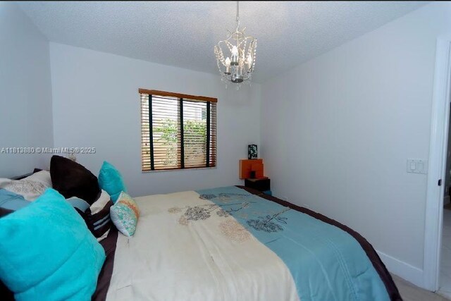 1353 Majesty Ter, Weston, FL 33327 - bedroom with a chandelier and a textured ceiling
