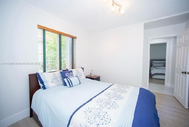 1353 Majesty Ter, Weston, FL 33327 - bedroom featuring light wood-style floors and baseboards