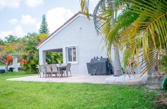1353 Majesty Ter, Weston, FL 33327 - back of house with stucco siding, a patio, and a yard