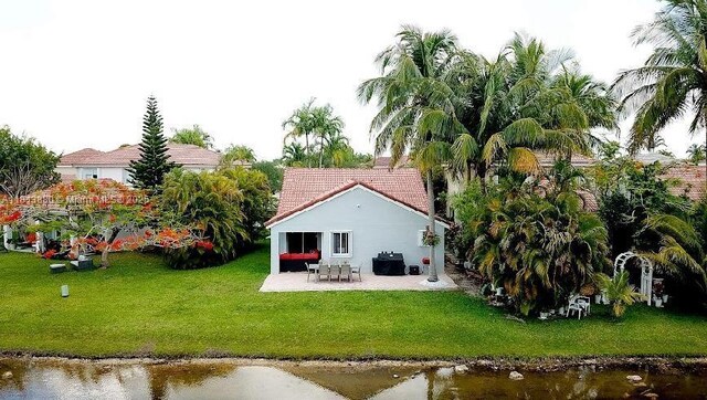 1353 Majesty Ter, Weston, FL 33327 - rear view of property with a patio, a yard, a water view, and a tiled roof