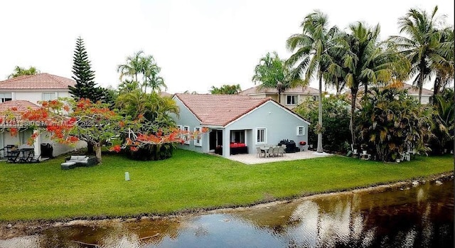 1353 Majesty Ter, Weston, FL 33327 - back of property featuring a water view, a patio, a yard, and a tiled roof