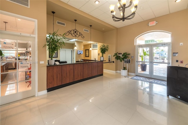 1353 Majesty Ter, Weston, FL 33327 - reception featuring a chandelier, a towering ceiling, and french doors