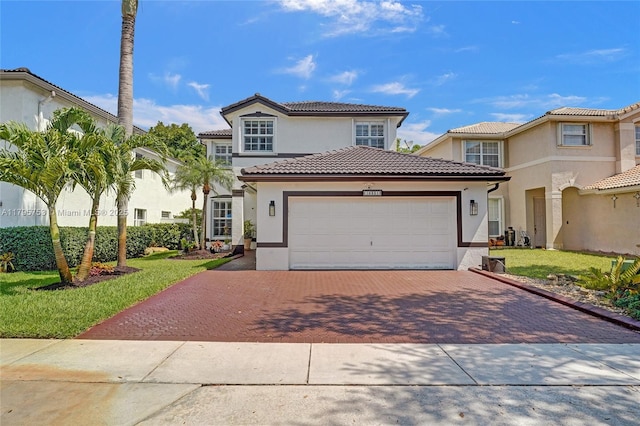 16331 SW 23rd St, Miramar, FL 33027 - mediterranean / spanish home featuring decorative driveway, stucco siding, a garage, a tiled roof, and a front yard