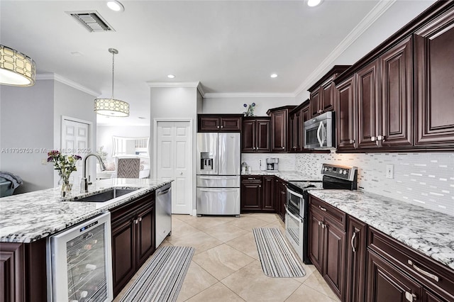16331 SW 23rd St, Miramar, FL 33027 - kitchen with stainless steel appliances, a sink, wine cooler, decorative backsplash, and light tile patterned floors