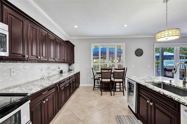 16331 SW 23rd St, Miramar, FL 33027 - kitchen featuring a sink, beverage cooler, tasteful backsplash, pendant lighting, and plenty of natural light