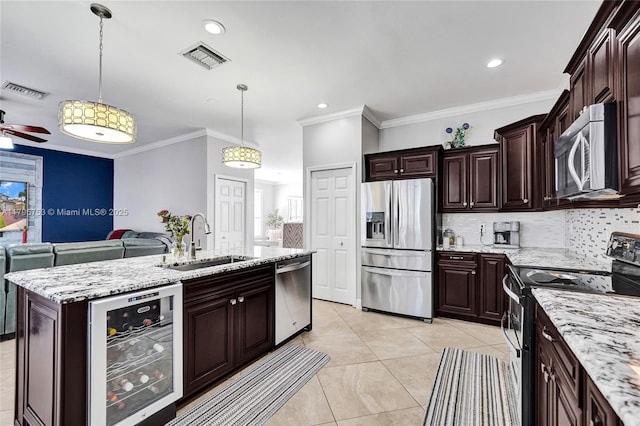 16331 SW 23rd St, Miramar, FL 33027 - kitchen featuring stainless steel appliances, a sink, wine cooler, open floor plan, and tasteful backsplash