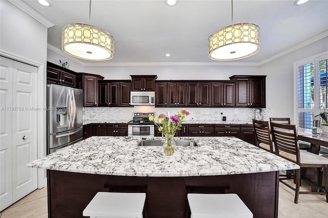 16331 SW 23rd St, Miramar, FL 33027 - kitchen with stainless steel appliances, a sink, ornamental molding, a kitchen bar, and decorative backsplash