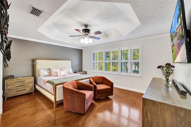 16331 SW 23rd St, Miramar, FL 33027 - bedroom with wood finished floors, crown molding, a tray ceiling, a textured ceiling, and baseboards