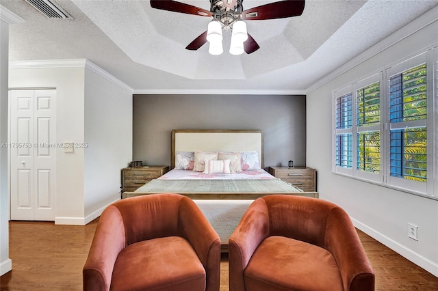 16331 SW 23rd St, Miramar, FL 33027 - bedroom featuring a raised ceiling, wood finished floors, baseboards, a textured ceiling, and crown molding
