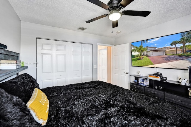 16331 SW 23rd St, Miramar, FL 33027 - bedroom with a textured ceiling, a closet, and ceiling fan