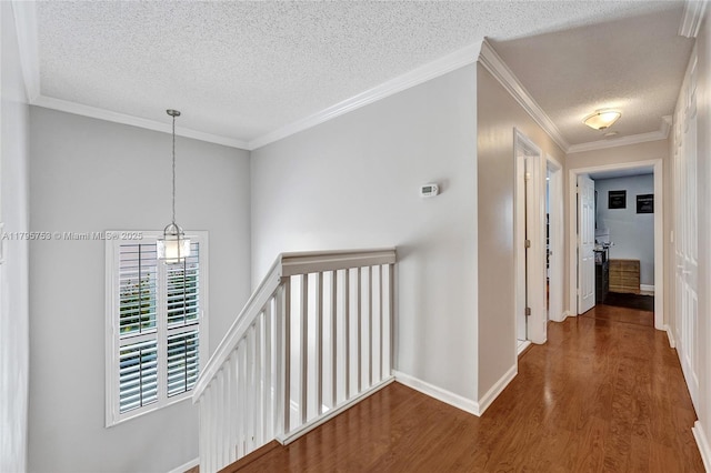 16331 SW 23rd St, Miramar, FL 33027 - corridor featuring an upstairs landing, wood finished floors, a textured ceiling, baseboards, and a chandelier