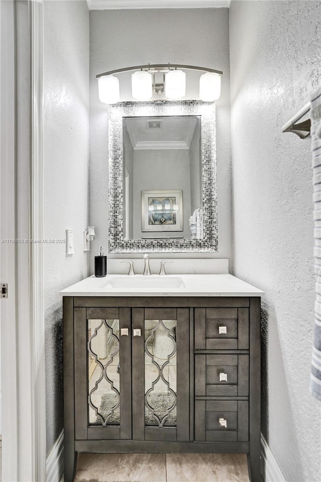 16331 SW 23rd St, Miramar, FL 33027 - bathroom with vanity, a textured wall, baseboards, and ornamental molding