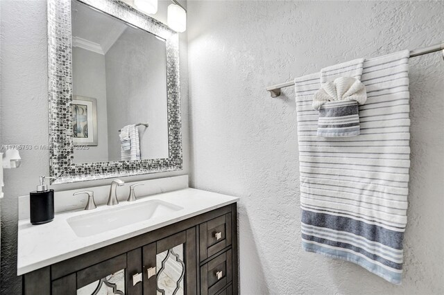 16331 SW 23rd St, Miramar, FL 33027 - bathroom featuring a textured wall, crown molding, and vanity