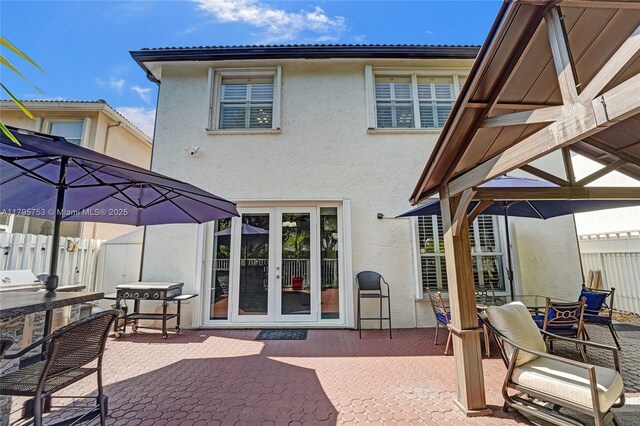 16331 SW 23rd St, Miramar, FL 33027 - rear view of property with stucco siding, a patio, a gazebo, and french doors