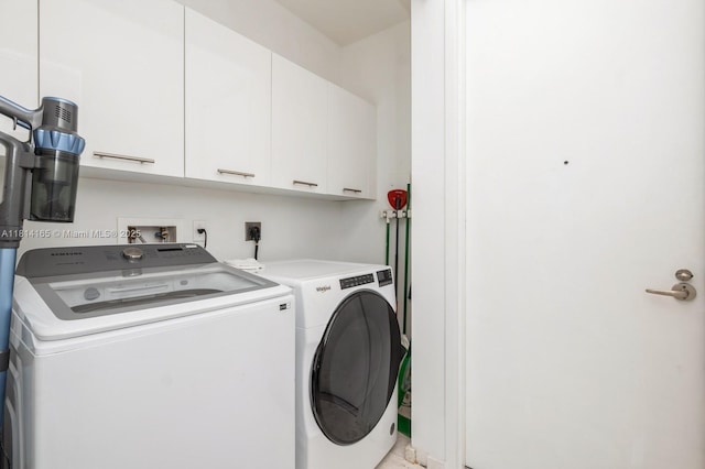900 Brickell Key Blvd Unit 1702, Miami, FL 33131 - washroom featuring washer and clothes dryer and cabinet space