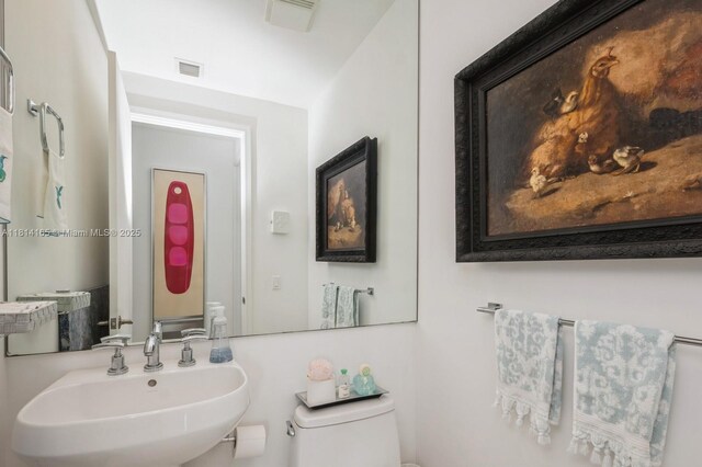 900 Brickell Key Blvd Unit 1702, Miami, FL 33131 - half bathroom with a sink and toilet