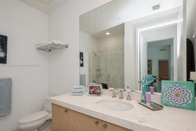 900 Brickell Key Blvd Unit 1702, Miami, FL 33131 - bathroom featuring vanity, a shower stall, and toilet