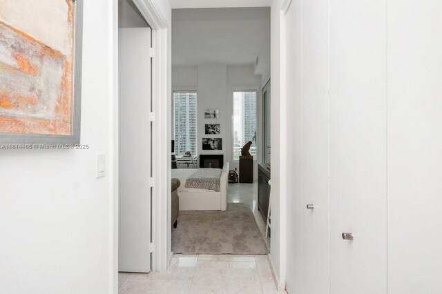 900 Brickell Key Blvd Unit 1702, Miami, FL 33131 - hall featuring light carpet, light tile patterned floors, and baseboards