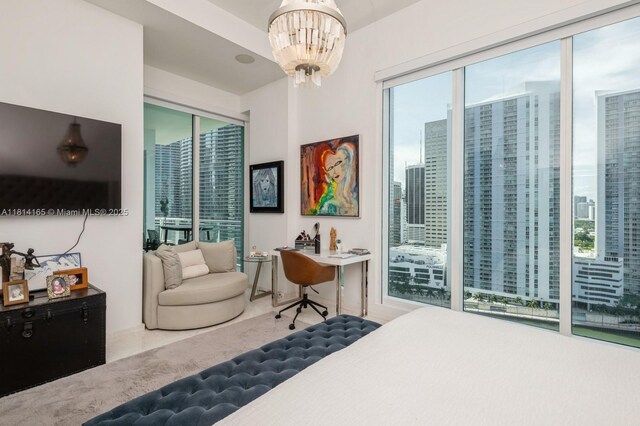 900 Brickell Key Blvd Unit 1702, Miami, FL 33131 - bedroom featuring a chandelier, a city view, and access to outside