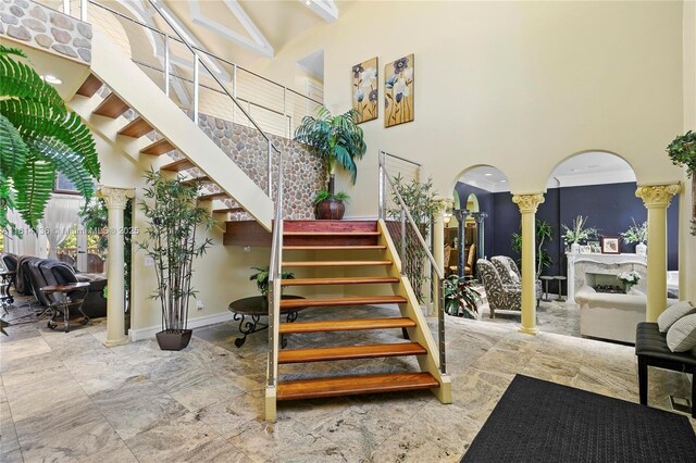 200 Asphodel Dr, Al, ,, AL 36303 - stairs featuring ornate columns, a towering ceiling, arched walkways, and stone finish flooring
