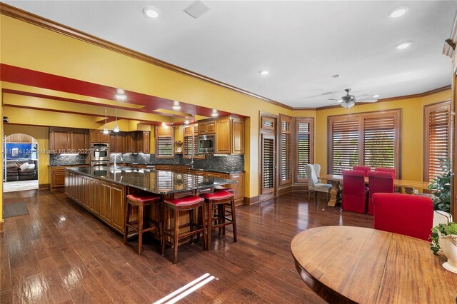 200 Asphodel Dr, Al, ,, AL 36303 - kitchen featuring stainless steel appliances, ornamental molding, a spacious island, brown cabinetry, and a ceiling fan