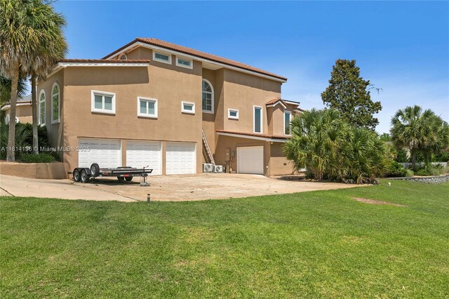 200 Asphodel Dr, Al, ,, AL 36303 - back of house with a garage, stucco siding, concrete driveway, and a lawn