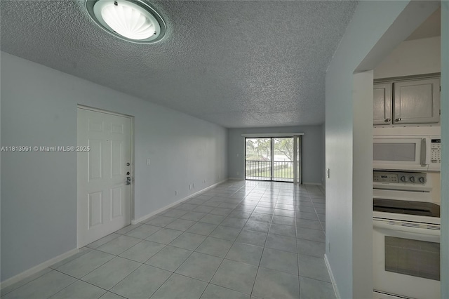 9965 Pineapple Tree Dr Unit 203, Boynton Beach, FL 33436 - spare room with a textured ceiling and light tile patterned floors