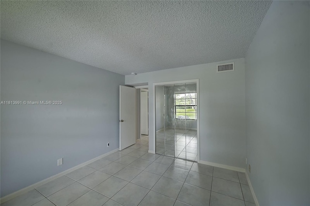 9965 Pineapple Tree Dr Unit 203, Boynton Beach, FL 33436 - empty room featuring a textured ceiling and light tile patterned floors