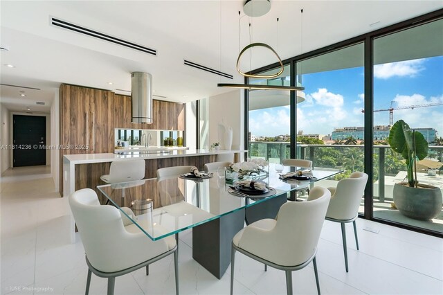9901 W Bay Harbor Dr Unit 601, Bay Harbor Islands, FL 33154 - dining room featuring expansive windows, healthy amount of natural light, and light tile patterned floors