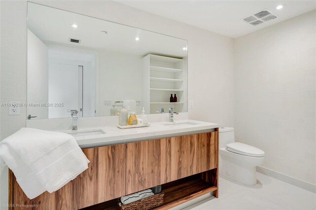 9901 W Bay Harbor Dr Unit 601, Bay Harbor Islands, FL 33154 - full bathroom with double vanity, toilet, recessed lighting, and baseboards