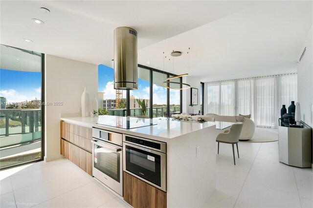 9901 W Bay Harbor Dr Unit 601, Bay Harbor Islands, FL 33154 - kitchen with oven, modern cabinets, island range hood, light countertops, and black electric stovetop