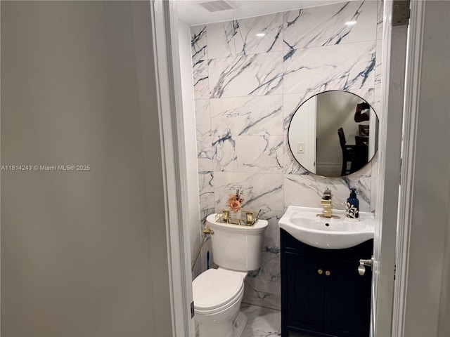7100 NW 17th St Unit 404, Plantation, FL 33313 - half bathroom with vanity, tile walls, toilet, and marble finish floors