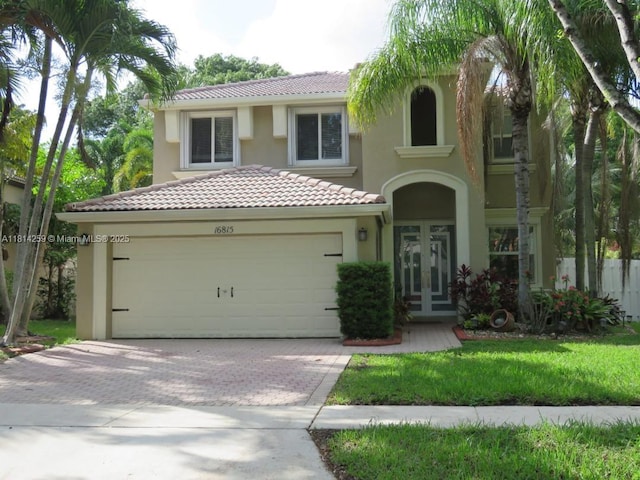 16815 SW 49th Ct, Miramar, FL 33027 - mediterranean / spanish house with stucco siding, a tile roof, driveway, and a garage