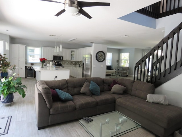 16815 SW 49th Ct, Miramar, FL 33027 - living room featuring plenty of natural light, a ceiling fan, stairway, and light wood-style floors