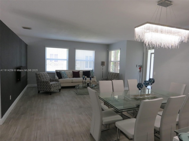 16815 SW 49th Ct, Miramar, FL 33027 - dining space with wood finished floors, a chandelier, and baseboards