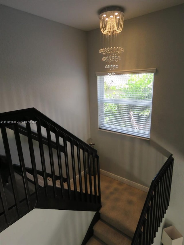 16815 SW 49th Ct, Miramar, FL 33027 - staircase featuring a chandelier, baseboards, and carpet flooring